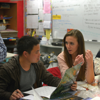 Two students engage in a conversation about service