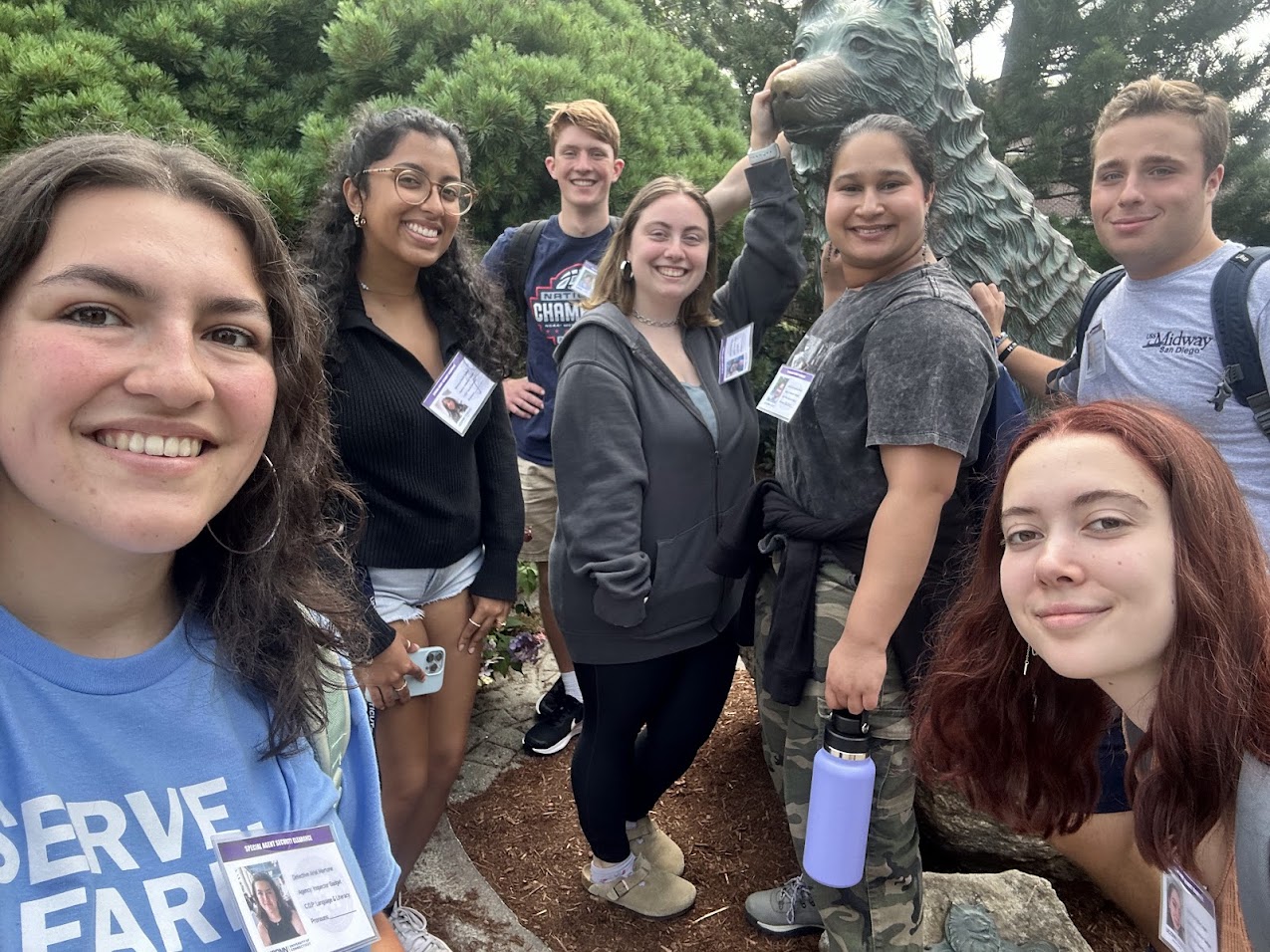 Community Outreach Student Leaders pose in front of Husky statue.