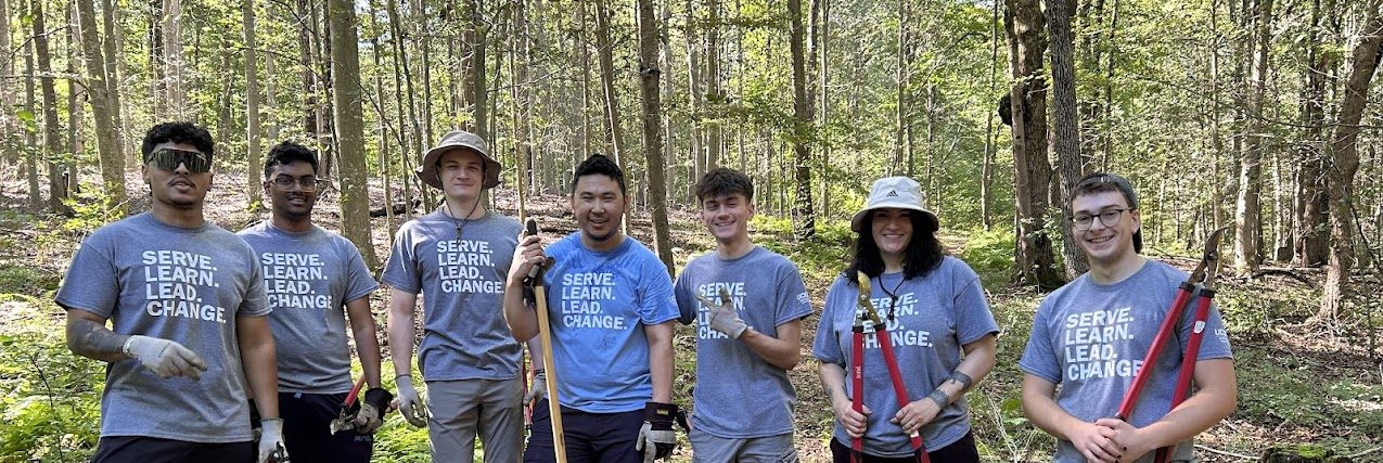 Community Outreach staff and volunteers smile while at a service site.