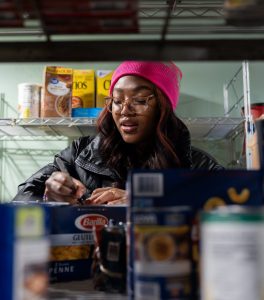 UConn students help sort through food in the Holy Family Home and Shelter's food pantry in Willimantic as part of the MLK Day of Service events on Jan. 15, 2024. (Sydney Herdle/UConn Photo)